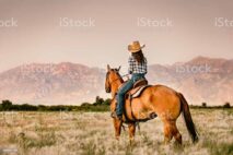 Cowgirl Horseback Riding in Utah at Sunset